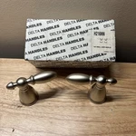 Delta H216NN - Two Small Lever Handles In Brilliance Pearl Nickel. Fixed Price $69.99.